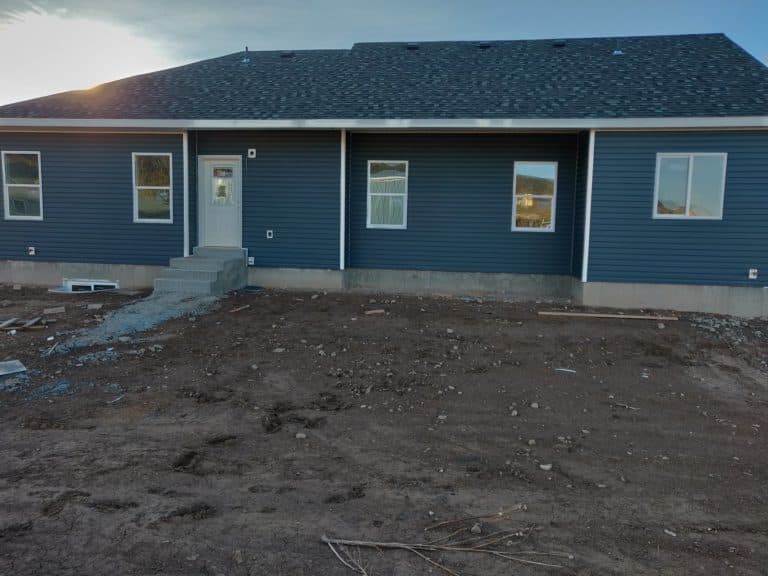 Front view of residential siding renovation in progress