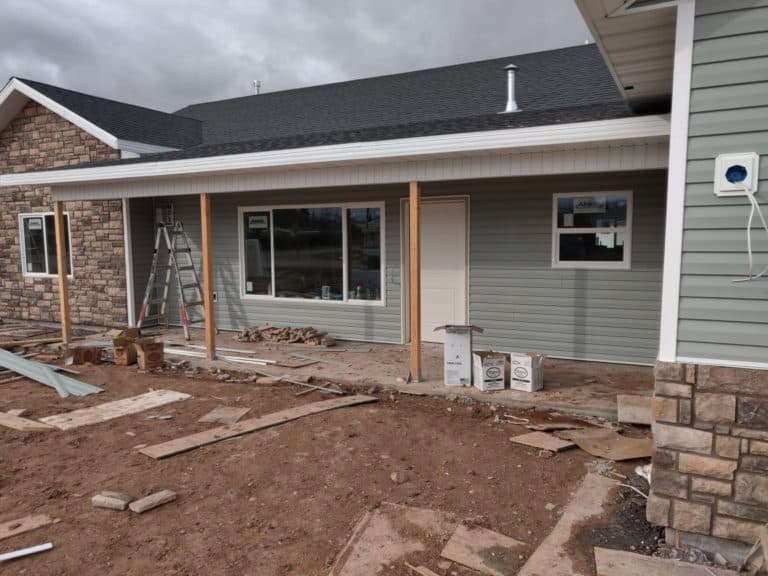 Completed siding project with crisp window trimming